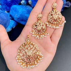 Featuring a delicately carved pearl pendant set in 22ct gold. This timeless piece will be adored for generations to come, making it the perfect addition to your jewelry collection. The pendant set weighs 28.50 GMs including 3.25 GMs in hanging pearl beads. Price Breakup Summary Component Rupees % of Total 22k Gold 123,664 77.2% Stones & Beads 9,621 6.0% Making Charges 22,260 13.9% Taxes (GST) 4,666 3.0% Total 160,211 100.0% View Detailed Price Breakup Watch Video Here Gold Meenakari Round Pendant Jewelry, Festive Gold Round Pendant Jewelry, Yellow Gold Kundan Pendant Necklace For Wedding, Wedding Yellow Gold Kundan Pendant Necklace, Wedding Jewelry Diwali Round Pendant, 22k Gold Jewelry With Flower Pendant For Wedding, 22k Gold Flower Pendant Jewelry For Wedding, Elegant Meenakari Round Pendant Jewelry, Diwali Pearl Pendant Necklace