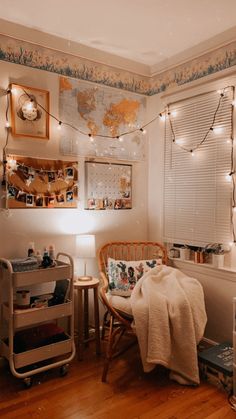 a bedroom with a bed, desk and chair in it next to a map on the wall