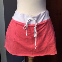 Coral mini skort Coral mini skort (mini skirt with shorts) with MAUI across the behind.  NWT.  Drawstring for adjustable waist.  Size says large but fits smaller sizes. Attitude Clothing Skirts Mini Casual Skirt With Waistband For Spring, Casual Mini Skirt With Waistband, Casual Summer Mini Skirt With Waistband, Summer Cotton Stretch Mini Skirt, Summer Stretch Cotton Mini Skirt, Stretch Cotton Mini Skirt For Summer, Cotton Stretch Skort For Day Out, Stretch Cotton Skort For Day Out, Casual Cotton Tennis Skirt With Elastic Waistband