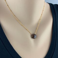 "Smoky Quartz Pendant Simple Necklace Minimalist Necklace Necklace for Women Gemstone Necklace Layering Necklace Dainty Necklace Gift for Her Appearing to float, the bold brownish grey Smoky Quartz balances perfectly on this delicate Satellite Chain. We have threaded the chain through the stone for extra drama. The chain is finished with delicate Smoky Quartz Rondels at the closure and end of the two inch extension. Our Smoky Quartz Pendant is a perfect day to night piece that needs little intro Minimalist Oval Pendant Necklace As Gift For Her, Everyday Gemstone Round Pendant Necklace, Minimalist Birthstone Crystal Necklaces For Jewelry Making, Dainty Everyday Necklaces With Round Stone, Everyday Round Gemstone Crystal Necklace, Everyday Gemstone Necklace With Round Pendant, Minimalist Birthstone Pendant Necklace With Adjustable Chain, Modern Natural Stone Necklaces For Gifts, Modern Necklaces With Natural Stones For Gifts