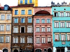 several different colored buildings are lined up against each other