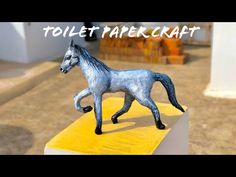 a toy horse is standing on top of a yellow block with the words toilet paper craft above it