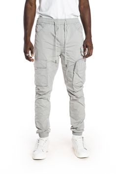 - Slim jogger fit- 100% Polyester- Light Grey- Non-stretchy woven fabric- Metal string tip- Cargo pockets with hidden snap- 3D zipper pocket- Waist size adjustable with elastic band and string Athleisure Tapered Leg Pants With Cargo Pockets, Casual Gray Tapered Leg Cargo Pants, Nylon Tapered Leg Pants With Side Pockets, Gray Cargo Pants With Elastic Waistband For Streetwear, Gray Elastic Waistband Cargo Pants For Streetwear, Gray Athleisure Pants With Pockets, Casual Trousers With Functional Pockets, Nylon Tapered Leg Bottoms With Pockets, Athleisure Cotton Bottoms With Functional Pockets