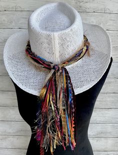 This vibrant hat band will add a festive splash of color to a variety of hats all throughout the year!  This hat band will make quite the statement worn on any color hat!   Made with unique specialty yarn of beautiful colors and textures, each band comes pre knotted to fit the standard size hat of 24" but the back knot can be untied and adjusted if needed.  The tail part of this hat band measures 10 inches.  If a different tail length is desired please just note it on the order. The width of the Adjustable Brimmed Hats For Music Festival, Trendy Hats For Kentucky Derby Festival, Country Style Fedora For Kentucky Derby Festival, Trendy Brimmed Festival Hats, Trendy Brimmed Hats For Festivals, Trendy Adjustable Hat Bands For Kentucky Derby, Trendy Curved Brim Fedora For Festival, Bohemian Adjustable Fedora For Spring, Adjustable Hats For Spring Music Festival