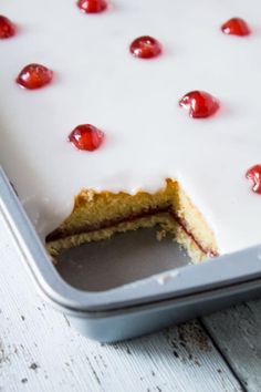 a cake in a pan with cherries on it