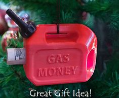 a red gas pump ornament hanging from a christmas tree with the words great gift idea