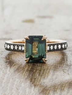 Different Engagement Ring Settings, Vintage Color Engagement Rings, Unique Engagement Rings Not Diamond, Moody Engagement Ring, Emerald Vintage Ring, Green Sapphire Ring Engagement, Emerald Cut Green Sapphire Ring, Engagement Ring With Emerald Accents, Emerald And Gold Ring