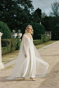 a woman in a white wedding dress and veil