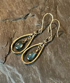 These beautiful, bohemian style dangles feature handcrafted, artisan, gold bronze hoops, with smooth, blue flash labradorite gemstones. The gems are wire wrapped in gold filled wire. The gorgeous ear wires are handcrafted in gold bronze. Total length is approximately 2 inches.  Earrings will arrive in a gift box.  Please ensure that your correct address is listed when you place your order. Terra Glass and Gems is not responsible for lost, stolen, damaged, or misplaced packages. Handmade Brass Dangle Chandelier Earrings, Bohemian Teardrop Jewelry With Ear Wire, Handmade Brass Chandelier Dangle Earrings, Bohemian Silver Drop Jewelry, Handmade Vintage Long Drop Jewelry, Bohemian Wire Wrapped Earrings For Festivals, Artistic Wire Wrapped Drop Earrings, Adjustable Bohemian Dangle Earrings, Bohemian Handmade Dangle Earrings