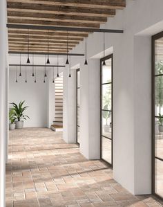 an empty room with wooden beams and hanging planters on the ceiling is shown in this rendering