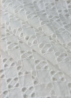 an image of white lace on fabric