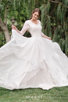 a woman in a wedding dress is posing for the camera