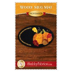 the woolly mug mat is decorated with autumn leaves and acorns on it