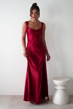 This gown is your perfect choice for debs, prom or any formal event. A look that blends classic glamour with contemporary style. Designed for timeless allure and effortless sophistication. Featuring a graceful cowl neckline and thick shoulder straps, this dress offers a flattering, structured fit. The sultry thigh-high slit adds a bold, modern touch, while the luxurious satin fabric drapes beautifully to enhance your silhouette. Highlights Stunning red gown with cowl neckline Soft satin material Floor Length V Neck Red Dress, Red Bridesmaid Dresses Sposadresses, Long Red Dress Formal Bridesmaid, Red Long Dress Formal Nordstrom, Elegant Long Dresses Red, Strap Dresses Formal, Womens Red Satin Dress, Red Wedcding Guest Dress, Dressy Red Dresses