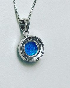 "Blue Opal Halo Necklace Minimalist and Dainty Necklace Metal: All components are made from solid .925 Sterling Silver Stone: 8mm Lab Created Opal; Cubic Zirconia Measurement: Pendant Height is 19mm (0.75\") including bail and 13mm (0.51\") wide Choose Chain Length Please feel free to Convo me with any questions before purchasing. Please view policy before purchasing Other Opal Necklaces can be found here https://www.etsy.com/shop/LinksAndStones?ref=ss_profile&section_id=24284450 Thank You F Silver Pendant Birthstone Necklace For Wedding, Silver Round Birthstone Necklace For Wedding, Blue Round Pendant Necklace For Formal Occasions, White Gold Sterling Silver Birthstone Necklace For Wedding, Formal Blue Round Pendant Necklace, Silver Round Pendant Birthstone Necklace, Silver Pendant Birthstone Necklace With Bezel Setting, Silver Birthstone Pendant Necklace With Bezel Setting, Silver Birthstone Necklace With Round Pendant