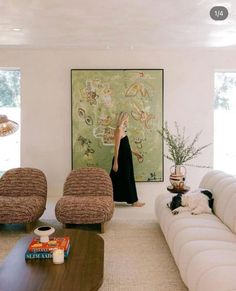 a woman standing in the middle of a living room