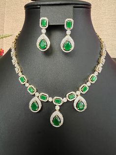 Designer Green Emerald AD Stones  Micro gold Finish  Necklace and Earring Set / Bridal Jewelry / South Indian Jewelry This item is perfect for parties and festivals! DETAILS: Includes one necklace and two earrings. Necklace: 13.5inches. Adjustable length. Chain closure. Weighs 1.45 oz ( 41g).  Earrings: 1.3 inch(es) long. Earring set weighs 0.35 oz (11 g). Earring backs push on/off. Material: Imitation gold Finish Green Emerald  AD Stones Cubic zirconia stones. Finish: Premium Micro gold finish.  NOTE: I try my best to show you photos of my products as they appear in real life, but please note that variations in color occur due to differences in lighting and screen settings.  PRODUCT CARE: - Avoid contact with heat/fire, water, and chemicals such as perfumes or any sprays to prevent produc Gold Plated Jewelry Sets For Party, Diwali Jewelry Sets With Matching Earrings For Celebration, Diwali Celebration Jewelry Sets With Matching Earrings, Gold Plated Hand Set Jewelry For Parties, Hand Set Gold Plated Jewelry Sets For Party, Party Gold Plated Hand Set Jewelry Sets, Gold Plated Green Jewelry For Diwali, Green Gold Plated Jewelry For Diwali, Gold Sets With Matching Earrings For Festive Occasions