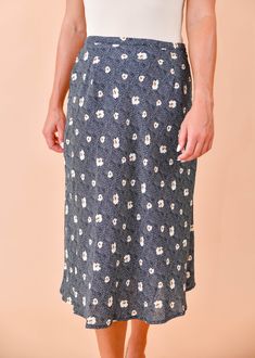 We are loving this fun & flirty midi skirt for any season! A pretty blue and beige floral print dances across this flattering, midi cut, woven fabric as it tumbles from a high waist. Pair this pretty piece with a distressed tee, knit, or a lacy cami for a perfect date-night ensemble! Hidden side zipper Lined 100% Polyester, 100% Rayon (lining) True to size Our model Karin is wearing a size Small Flowy Summer Midi-length Bottoms, Blue Flowy Floral Print Bottoms, Flowy Floral Print Rayon Skirt, Trendy Summer Midi Length Bottoms, Trendy Summer Midi Bottoms, Fitted Mid-length Summer Skirt, Spring Floral Print Flowy Skirt, Spring Rayon Lined Skirt, Spring Lined Rayon Skirt