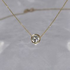 Our most requested necklace for the holidays, featuring a timeless half carat solitaire diamond necklace. Simplistic beauty with unparalleled sophistication. DETAILS: - .50 carat solitaire diamond, G SI+, 5.5 mm - Set in a 14k gold bezel setting - 14k gold cable chain with a lobster clasp closure, 0.5 mm - Custom/larger chains are available upon request - Available in 14k white, yellow or rose gold - Sizes 15 - 20 inches *18k gold and custom lengths available upon request **GIA or EFL certified Diamond Solitaire Necklaces, Bezel Set Diamond Necklace, Fine Jewelry 14k Gold Solitaire Necklace With Brilliant Cut, Bezel Diamond Necklace, Gold Solitaire Necklace With Lab Grown Diamond For Anniversary, Timeless Lab Grown Diamond Necklace For Anniversary, Classic Everyday Jewelry With Tension Setting, Classic Solitaire Necklace With Bezel Setting, 14k Gold Solitaire Necklace With Brilliant Cut