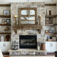 a living room with a stone fireplace and shelves