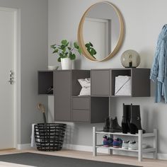 there is a coat rack with shoes on it and a mirror above the shoe cabinet