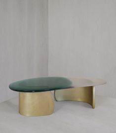 an oval glass table sitting on top of a white floor