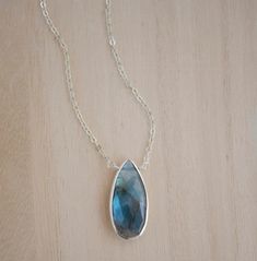 Labradorite, a feldspar originally found in Labrador Island, Canada, was believed to be fallen fire from the Aurora Borealis by the Inuit people. It is a protective gemstone, said to help support us through transformation and everyday life changes. Labradorite is also believed to hold the energies of creativity, courage, and leadership.This necklace is handcrafted with a natural, faceted Labradorite teardrop bezeled in sterling silver or 22k gold vermeil (gold over sterling silver). Each stone i Teardrop Gemstone Jewelry For Meditation, Nature-inspired Teardrop Gemstone Jewelry, Teardrop Pendant Jewelry With Natural Inclusions For Healing, Labradorite Drop Jewelry For Gift, Nature-inspired Teardrop Gemstone Necklaces, Handmade Labradorite Drop Jewelry, Spiritual Teardrop Large Stone Jewelry, Nature-inspired Teardrop Pendant Jewelry For Healing, Handmade Labradorite Drop Necklaces