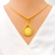 This stunning 22k gold pendant, weighing 7.8 grams, features an intricate engraved design that showcases exceptional craftsmanship. The yellow gold finish highlights the detailed engravings, making it a captivating accessory for any occasion. With a length of 1.75 inches, this pendant balances boldness and elegance perfectly. Ideal for those who appreciate detailed artistry and high-quality gold, this pendant can be paired with any chain of your choice. Its elaborate design and luxurious appeal make it a treasured addition to any jewelry collection, adding a touch of timeless beauty to any outfit. PRODUCT DETAILS Gold Purity(karat): 22k Gold Weight(grams): 7.8 Item Finish: Yellow Gold Pendant Length: 1.75" Chain: Not Included 22k Gold Engraved Medallion Jewelry, Engraved 22k Gold Medallion Jewelry, 22k Gold Engraved Medallion Necklace, Engraved 22k Gold Medallion Necklace, 22k Gold Medallion Necklace Engraved, 22k Gold Engraved Necklace For Ceremonial Occasions, Gold Oval Pendant Necklace For Ceremonial Occasions, Traditional Coin Pendant Jewelry For Formal Occasions, Traditional Coin Pendant Jewelry For Formal Events