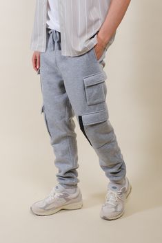 Discover the ideal fusion of work-ready functionality and urban style with our Fleece Utility Cargo Sweatpants. Designed to seamlessly transition between work and leisure, these sweatpants boast a relaxed yet refined fit that exudes effortless sophistication. Elevate your ensemble with the utility-inspired cargo pocket details, providing ample space for your essentials while adding a dash of rugged charm. The elastic waist and ankles ensure a snug yet flexible fit, allowing you to conquer any ta Casual Joggers With Functional Pockets For Jogging, Sporty Cargo Pants With Ribbed Cuffs For Streetwear, Urban Style Cargo Pants For Jogging, Gray Cotton Sweats With Side Pockets, Sporty Cotton Cargo Pants With Ribbed Cuffs, Casual Jogging Pants With Functional Pockets, Casual Jogging Bottoms With Functional Pockets, Athleisure Streetwear Joggers With Hip Pockets, Athleisure Joggers With Hip Pockets For Streetwear