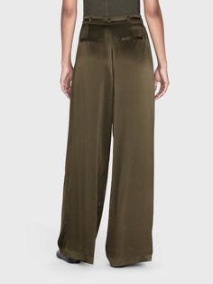 A 100% silk high rise, wide-leg trouser with front center pleats for a dramatic silhouette that drapes beautifully. Featuring a skinny waist tie for an adjustable fit and side and back pockets. High Rise FitDry Clean Only100% Silk13.25" Front Rise/32" Inseam/28.5" Leg Opening Military Style Wide Leg Pants With Belt Loops, Military Style Full Length Pants With Side Pockets, Green Military-style Long Pants, Relaxed Fit Military Bottoms With Belt Loops, Military Trousers With Belt Loops, Dramatic Silhouette, Pleat Dress, Silk Trousers, Timor Leste