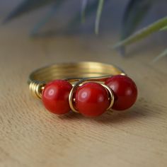 "Handmade Three Red Coral Gemstones, and Sterling Silver, Yellow, or Rose Gold Filled Wire Wrapped Ring; Custom Made to Size ❀ This gemstone wire wrapped ring is handmade with three approximately 6mm in diameter red coral beads and your choice of wire for the band. ❀ This ring (as well as all the others in my shop) is custom made to any size from 4 to 14 including half and quarter sizes! ❀ This ring can be made in Sterling Silver Filled Wire, Argentium Sterling Silver wire (tarnish resistant ste Wire Wrap Ring, Coral Ring, Wrap Ring, Argentium Silver, Wire Wrapped Rings, Beads And Wire, Wrap Rings, Red Coral, Wire Wrap