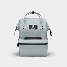 the back view of a grey backpack with black handles and two zippers on each side