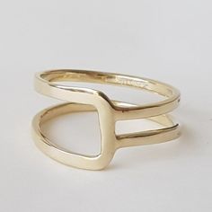 14K solid gold ring in a minimalist style for lovers of geometric shapes.◈ DETAILSWeight: 3gWidth upper part-9mm / 0.35''Thickness-1.3 mm / 0.05''◈ MATERIAL14K Solid Gold - Smooth,shiny,plain surface◈ ALSO AVAILABLE IN 14K/18K/9K Yellow, Rose, or White Gold◈ ENGRAVING is optional◈ SHIPPING is insured express and free worldwide◈ GIFT WRAPPING is included with every purchase✧ Back to my shop for more handcrafted gold jewelry:https://etsy.me/38Cs5ZlIf you have any questions, I will be happy to help Adjustable Modern Initial Ring In 14k Gold, Modern Adjustable 14k Gold Initial Ring, Modern Adjustable Initial Ring With Open Design, Modern Adjustable Initial Open Ring, Modern Adjustable Stackable Rings With Open Band, Modern Adjustable Initial Ring For Everyday, Modern Adjustable Stackable Rings With Simple Design, Modern Stackable Rings In Recycled Gold For Anniversary, Adjustable Yellow Gold Stackable Rings Modern Style