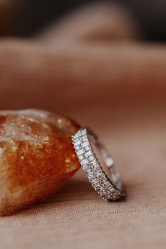 two wedding rings sitting on top of a piece of bread next to an orange peel