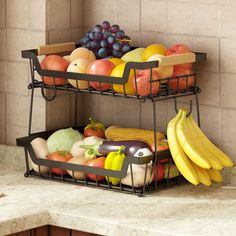 two metal baskets filled with different types of fruits and vegetables on top of a counter