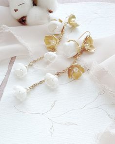 Delicate feminine wedding boho earrings. Earrings are fully handmade of gold-plated brass elements and hand-created foam flowers with tiny pearls in the middle, placed on the delicate chain. ❤️ earrings length 3.5 inches (9 cm) ❤️ earrings width 0.6 inch (1,5 cm) ❤️ earrings are very light weight and comfortable ❤️ made of gold-plated brass elements, tiny chain and hand crafted flowers ❤️ antiallergic nickel-free ear wire ❤️ different color option available - ask for details ❤️ ships within 5 da Yellow Gold Bridal Earrings With Latkans For Wedding, Yellow Gold Latkans Bridal Earrings For Wedding, Gold Latkan Earrings For Wedding, Gold Latkans Earrings For Wedding, Gold Earrings With Latkans For Wedding, Gold Chandelier Earrings With Latkans For Wedding, Delicate Gold Linear Earrings With Pearl Drop, Gold Dangle Bridal Earrings With Latkans, White Bohemian Flower Earrings For Wedding