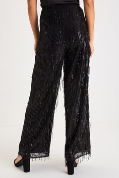 The most glamorous way to elevate any late-night look is with the Lulus Shimmery Aura Black Sequin Fringe High-Rise Wide-Leg Pants! Dazzling fringe-y sequin details adorn these mesh pants that feature a flattering high-rise fit and trendy wide pant legs that fall to full-length hems. Hidden side zipper/clasp. Pair with an equally shiny pair of heels for a truly stunning look! Fit: This garment fits true to size. Length: Ankle length. Size medium Inseam: 29.00 Front Rise: 12.50 Waist: Fitted - ve Elegant Sequined Bottoms For Gala, Elegant Sequined Bottoms For Holiday Party, Glamorous Fitted Bottoms For Holiday Party, Glamorous Holiday Party Bottoms, Sequin Bottoms For Date Night And Holidays, Holiday Trousers For Night Out, Festive Wide Leg Pants For Holidays, Glamorous Festive Pants, Glamorous Sequined Bottoms For Holiday Party