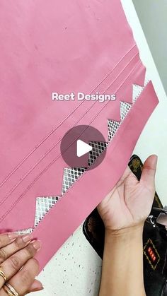 a person holding a pink piece of paper with the words reef designs on it and an image of someone's hand