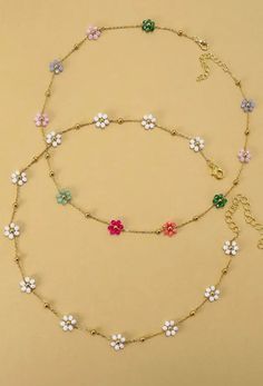 A vibrant charm necklace to brighten up your look! An arrangement of colorful beads intricately woven together to create a charming floral centerpiece.  DIMENSIONS Length: 15" Ext: 3' ball ext. Clasp: lobster claw Metal Finish: Gold Plated Product: Lead & Nickel Compliant Anti-tarnish: Double E-Coating Multicolor Beaded Necklace With Flower Charm For Summer, Multicolor Round Beads Flower Necklace For Summer, Multicolor Flower Necklace For Summer Beach, Spring Multicolor Beaded Flower Necklace, Multicolor Flower Charm Necklace For Summer, Summer Flower Charm Necklaces, Trendy Multicolor Flower Necklace For Summer, Summer Flower Pendant Necklace With Flower Charm, Trendy Flower Necklace For Beach