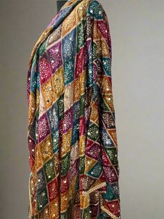 Experience the beauty of traditional Phulkari style with our Multicolor Dupatta. Made with a soft and luxurious silk finish, this dupatta features real mirror accents and stunning designs. Its heavy-weight construction makes it perfect for special occasions like Navaratri. Elevate your wardrobe with this must-have accessory. Approx 2.5 meters length Luxury Multicolor Dupatta For Puja, Luxury Bandhani Print Dupatta For Puja, Luxury Multicolor Handloom Dupatta, Luxury Jamawar Traditional Wear With Zari Weaving, Bohemian Sharara With Dupatta In Traditional Drape, Bohemian Sharara With Dupatta And Traditional Drape, Bohemian Choli With Sheer Dupatta In Chanderi, Bohemian Salwar Kameez With Sheer Dupatta For Navratri, Bohemian Chanderi Choli With Sheer Dupatta