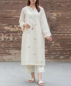 This outfit is crafted from soft Irish cotton, lined with gentle malmal, featuring an A-line cut. Adorned with scattered floral motifs, adding a unique and eye-catching touch to the design. The sleeves and trouser have delicate embroidery detailed, making it an exquisite piece. Spring Long Sleeve Kurta With Embroidered Cuffs, Off White Straight Kurta For Spring, Spring Kurta With Embroidered Cuffs And Long Sleeves, Spring Floral Embroidered Long Sleeve Pant Set, Spring Floral Embroidery Long Sleeve Pant Set, Traditional Spring Kurta With Set-in Sleeves, Off White Floral Embroidered Kurta For Spring, Festive Cotton Kurta With Embroidered Cuffs, Spring Sets With Embroidered Long Sleeves