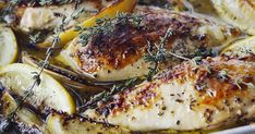 chicken with lemons and herbs in a pan