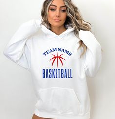 a woman wearing a white hoodie that says team name basketball