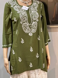 *mehndi green kurti  *Ethnic motifs plain  *round neck  ,short,regular sleeves  *Embroidery work on  neck  *Machine weave regular Cambric cotton  Bust:19.5 Waist:18 Hip:21 Length:30 Green Straight Kurta With Resham Embroidery, Bohemian Green Kurta With Motifs, Festive Green Tunic With Resham Embroidery, Festive Green Tunic, Green Festive Tunic, Green Chikankari Embroidery Top For Summer, Embroidered Green Straight Kurta Tunic, Embroidered Straight Kurta Tunic In Green, Green Straight Kurta With Motifs