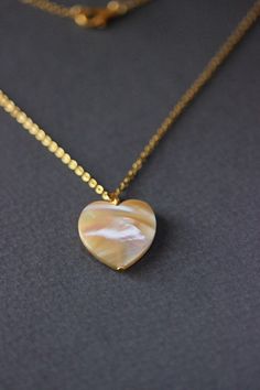 This delicate unique necklace was made of natural mother of pearl beige heart pendnat and high quality gold tone stainless steel chain with gold tone lobster claw. The chain is from lead & nickel free metal. Perfect jewelry for everyday wear and a great gift for someone special! The length of necklace is 45 cm or 17.7 inches. Other necklaces of my shop you can see here: https://www.etsy.com/shop/NaTavelli?section_id=14843046&ref=shopsection_leftnav_5 Thanks for a visit. Natural Stones Round Necklace For Her, Natural Stone Necklaces As Gift For Her, Natural Stones Necklace Gift For Her, Natural Stones Necklace For Her, White Spiritual Shell Necklace As A Gift, Spiritual White Shell Necklace Gift, White Spiritual Shell Necklace, White Heart Pendant Clavicle Chain Jewelry, White Heart Pendant Clavicle Chain