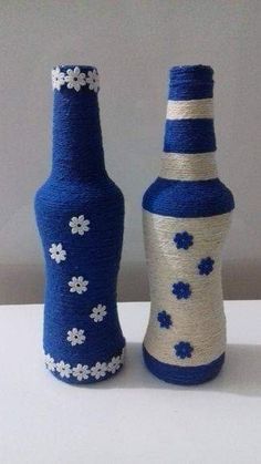 two blue and white vases sitting next to each other on top of a table