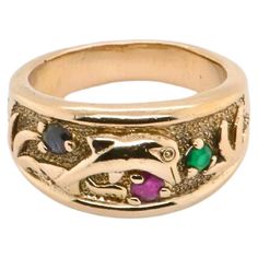 This yellow gold ring, dating from the 1960s, celebrates the beauty of nature with timeless elegance. Finely engraved with motifs evoking waves, a dolphin and plants, it embodies a unique artistic design. Three gemstones, a dazzling ruby, a deep blue sapphire and a sparkling emerald, all brilliant-cut, are harmoniously inlaid, creating a captivating tutti frutti effect. Weighing 5.3 grams and size 52, this ring is distinguished by its vintage charm and authentic character. A French hallmark guar Precious Stones Rings, Precious Rings, Vintage Style Rings, Diamond Free, Gold Ring Sets, Tutti Frutti, Stone Gold, Topaz Stone, Sapphire Stone