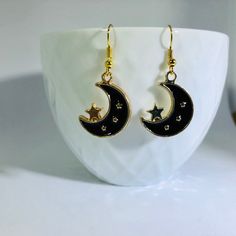 "Gold Plated Enameled Moon & Star Charm Earrings Material: Zinc Based Alloy (Lead and Nickel Safe) Size: 24mm x17mm (1\" x 5/8\") Color: Gold Plated/Black Nickel free ear-wire  Join my facebook group to see when new items are available- https://www.facebook.com/radcrafty Instagram- https://www.instagram.com/radberry1/"