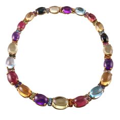 Italian made 18k gold necklace, set with multi color gemstone cabochons, including citrine, peridot, amethyst, tourmaline and topaz. DESIGNER: Not Signed MATERIAL: 18k Gold GEMSTONES: Tourmaline, Citrine, Topaz, Amethyst, Peridot DIMENSIONS: Necklace is 16.5" long and 15mm at the widest (center) point. MARKED/TESTED: 750, Italian mark. WEIGHT: 105.5 grams CONDITION: Previously Owned/Excellent Condition Elegant Multicolor Cabochon Gemstones, Luxury Multicolor Briolette Necklaces, Luxury Multicolor Briolette Necklace, Luxury Multi-stone Cabochons For Formal Occasions, Formal Multicolor Gemstone Necklaces, Fine Jewelry Multicolor Cabochon Gemstones, Formal Multi-stone Oval Cabochon Gemstones, Multicolor Cabochon Gemstones For Fine Jewelry, Multicolor Cabochon Gemstones Fine Jewelry