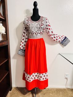 Item# W6 Design: Custom Made Country of Origin: Afghanistan  Price: $80 Material: Cotton, Embroidery, Zipper in back, charma dozi Shoulder: 18 inches Dress Length: 50.5 inches Sleeve Length: 24.5 Waist: 39 inches Chest: 42 inches This is beautiful Afghan short dress with embroidered around its neck and beautiful design Festival Anarkali Dress With Embroidered Neckline, Anarkali Dress With Embroidered Neckline For Festivals, Long Sleeve Dress With Embroidered Border For Festivals, Long Sleeve Anarkali Dress With Embroidered Border, Anarkali Dress With Embroidered Border And Long Sleeves, Traditional Festive Midi-length Dress, White Embroidered Dress For Holidays, Fitted Long Sleeve Dress With Embroidered Border, Festive Embroidered Midi Length Dress